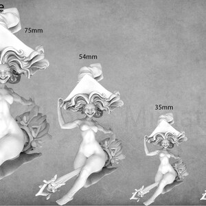 May include: Four different sizes of a miniature figurine of a woman riding a broomstick. The woman is wearing a large hat and has a mischievous expression on her face. The sizes are 75mm, 54mm, 35mm, and 32mm.
