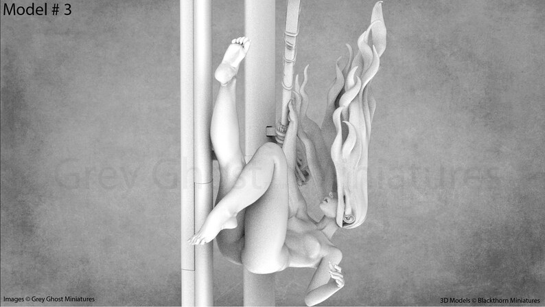 May include: A grayscale 3D printed model of a woman with long flowing hair, hanging upside down from a pole. The model is posed with one leg extended and the other bent at the knee. The woman's hair is styled in a flowing, flame-like shape.