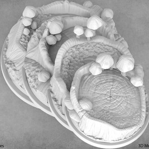 May include: A white, 3D printed miniature forest scene with a large tree stump in the center, surrounded by smaller mushrooms and trees. The scene is layered with different levels of terrain, creating a sense of depth.