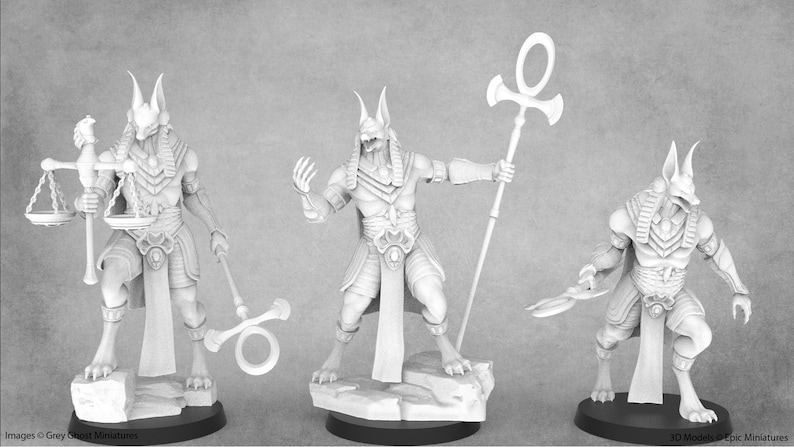 May include: Three detailed, white, 3D printed figurines of Anubis, the Egyptian god of the dead, in different poses. The first figurine holds a scale and an ankh. The second figurine holds an ankh and has its hand raised. The third figurine holds a knife and has its hand raised.
