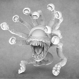 Puede incluir: Una miniatura impresa en 3D blanca de una criatura con un solo ojo grande, una boca abierta con dientes y múltiples tentáculos.