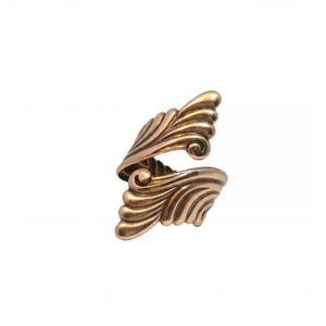 a gold-colored, ornate ring with a unique, intricate design.