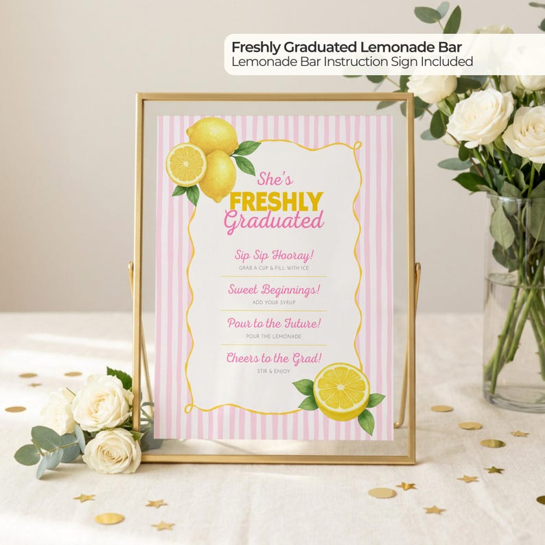 May include: A framed sign for a lemonade bar, featuring pink and white stripes and the text "She's Freshly Graduated." The sign includes instructions and lemon illustrations. A gold frame holds the sign, with flowers and confetti in the background.