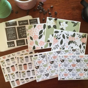 May include: An assortment of blank greeting cards with various coffee-themed designs. The cards feature illustrations of coffee cups, flowers, and text such as "Coffee love is brewing" and "Life begins after coffee".