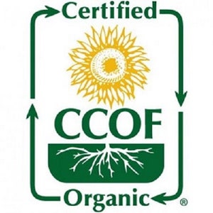 May include: A green and white logo with the words "Certified Organic" and "CCOF". The logo features a yellow sunflower in the center, with a green border that has arrows pointing in a circular direction. The word "Organic" is at the bottom.