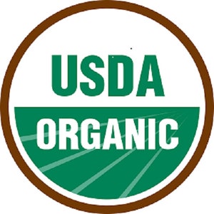 May include: A circular USDA Organic seal with a brown border. The words "USDA" and "ORGANIC" are in bold, white letters. The background behind the words "ORGANIC" is green with white lines.