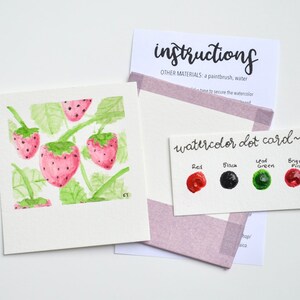 May include: Watercolor dot card with paint swatches in red, black, green, and pink. The card says "watercolor dot card" and has the words "Red", "Black", "Leaf Green", and "Bright Pink" written above the swatches. The card is next to a watercolor painting of strawberries on a vine.