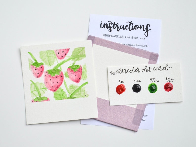 May include: Watercolor dot card with paint swatches in red, black, green, and pink. The card says "watercolor dot card" and has the words "Red", "Black", "Leaf Green", and "Bright Pink" written above the swatches. The card is next to a watercolor painting of strawberries on a vine.