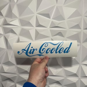 May include: White vinyl sticker with blue cursive text that reads "Air Cooled".