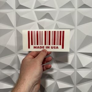 May include: A white sticker with a red barcode and the text "MADE IN USA".