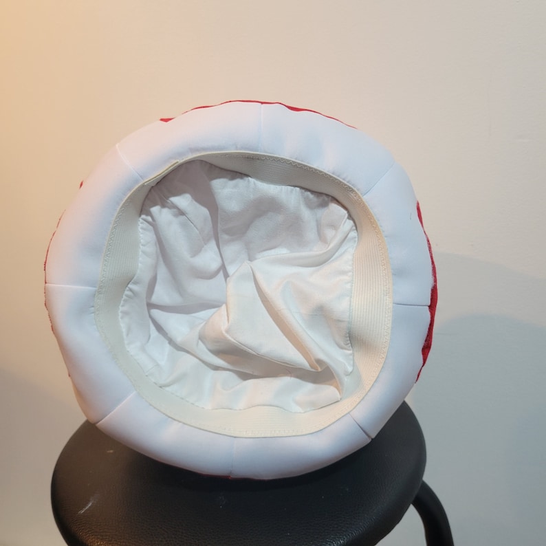 Photo of underview of the mushroom hat showing a full lining and an elastic that acts like a headband to keep the hat in place.