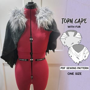 May include: A dark gray torn cape with gray fur trim is displayed on a red dress form. The text "Torn Cape with Fur" and "PDF Sewing Pattern One Size" are visible.