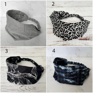 May include: A collection of four fabric headbands featuring an elastic back strap. One is solid heather gray, one has a black and white leopard print, one is black with a white leaf pattern, and one has a dark blue and black abstract geometric print.