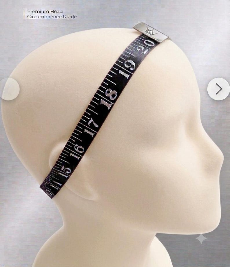 May include: A black measuring tape labeled Premium Head Circumference Guide wrapped around a beige mannequin head. The tape features white numerical markings from 14 to 20 inches, with a silver metal clasp at the top displaying a crown logo.