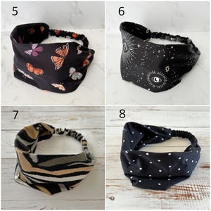 May include: Four fabric headbands with elastic back bands. Number 5 is black with orange and purple butterflies. Number 6 is black with white celestial eye and star patterns. Number 7 has tan, gray, and black stripes. Number 8 is black with white polka dots.
