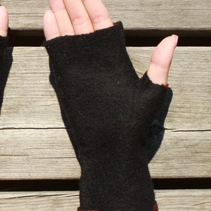 Black fingerless mitts were made of 100% merino wool.