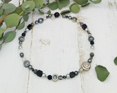 elegante Kette mit Sterlingsilber Schnecke, Hämatit, Polaris und funkelnden Glaskristallen