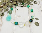 extravagante Kette mit Muranoglaslinse, Blumen und Puschel