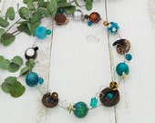 extravagante Statement Kette mit Muschelscheibe und Schnecke