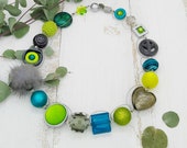 extravagante Kette mit Muranoglas und Puschel