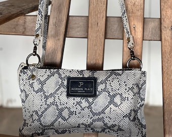 Snake Embossed Leather Crossbody Clutch: Adjustable Strap, Brass Hardware
