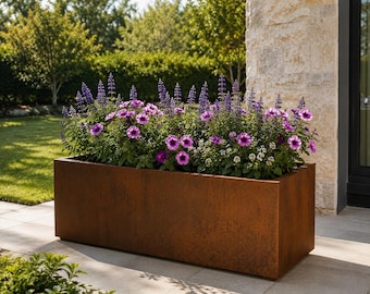 May include: A rectangular planter with a weathered, rust-coloured metal finish filled with vibrant purple petunia flowers and tall, slender spikes of blue salvia blossoms, creating a dense arrangement of colourful petals and green foliage.