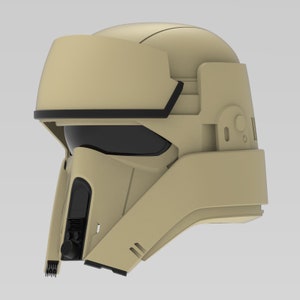 Könnte beinhalten: Ein beiger Helm mit schwarzem Visier und schwarzem Besatz am oberen Rand. Der Helm hat eine strukturierte Oberfläche und einige Details an der Seite.