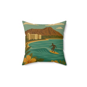 May include: A square throw pillow featuring a graphic illustration of a surfer on a yellow surfboard in teal ocean waves. The background displays a sandy beach, a large brown mountain, multi-story buildings, and yellow hibiscus flowers.