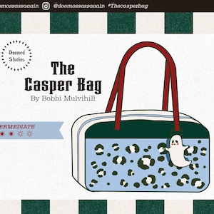 May include: The Casper Bag by Bobbi Mulvihill, a rectangular handbag with a blue leopard print design and a white ghost charm. The bag has a dark green top and red handles. The text "The Casper Bag" is displayed in a bold, stylized font.