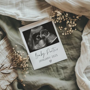 May include: A black and white ultrasound image of a baby in a white frame with the text "Baby Porter January 2025" and a small heart symbol.