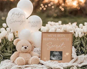 May include: A pregnancy announcement featuring white balloons with text, a teddy bear, and a wooden sign. The sign reads "We've been keeping a little secret..." and includes an ultrasound image. The balloons say "Baby Sweeny" and "August 2025".
