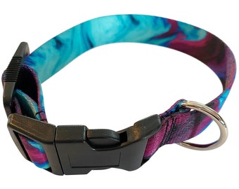 May include: A blue and purple tie-dye dog collar with a black plastic buckle and a silver metal D-ring.