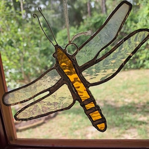 Dragonfly stained glass sun catcher 1offered .  Gold body with textured clear wings