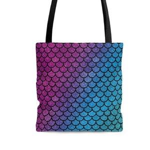 May include: A tote bag with black handles and a mermaid scale pattern in shades of pink, purple, blue, and teal.