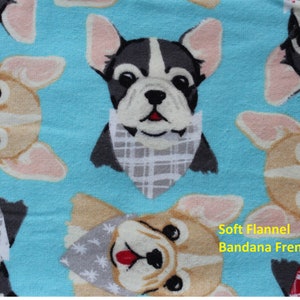 May include: Soft flannel fabric with a repeating pattern of French Bulldogs wearing bandanas. The dogs are in various colors, including tan, black, and white, set against a light blue background. The text "Soft Flannel Bandana Frenchie" is visible.
