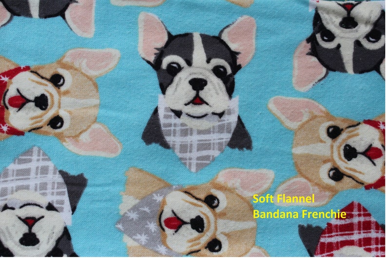 May include: Soft flannel fabric with a repeating pattern of French Bulldogs wearing bandanas. The dogs are in various colors, including tan, black, and white, set against a light blue background. The text "Soft Flannel Bandana Frenchie" is visible.
