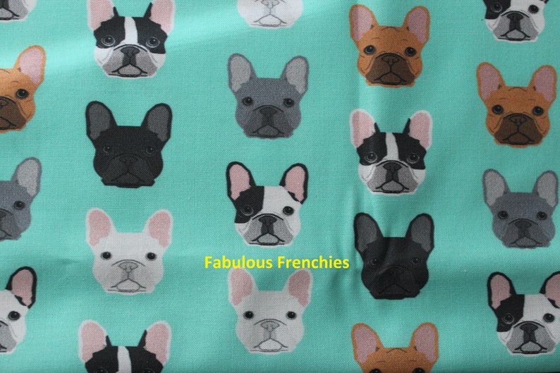 May include: A teal fabric featuring a repeating pattern of French Bulldog faces in various colors, including black, brown, gray, and white. The text "Fabulous Frenchies" is printed on the fabric.