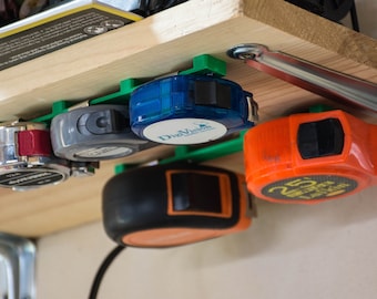 Tape measure hanger (under shelf or wall)