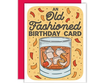 以下が含まれることがあります： カクテルのイラストが描かれた黄色の誕生日カード。カードには「An Old Fashioned Birthday Card」と書いてあります。