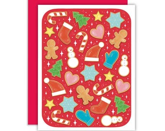 May include: A festive Christmas card featuring a red background with various holiday-themed cookie illustrations. The cookies include gingerbread men, candy canes, stars, mittens, Christmas trees, and snowmen. The card has a red border.