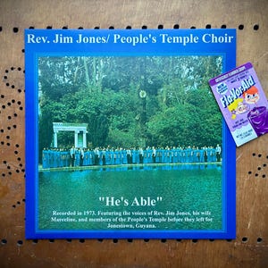 May include: Album cover for "He's Able" by Rev. Jim Jones/People's Temple Choir, featuring a blue border and a photo of a choir by a body of water. Includes text about the recording and a vintage Fla-Vor-Aid packet.