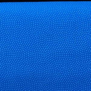 May include: A close-up of a bright blue fabric with a subtle textured pattern. The fabric has a smooth, even surface and a slightly shiny finish.