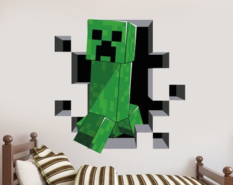 May include: A green Minecraft Creeper character wall decal, appearing to break through a wall of gray blocks. The decal is a 3D effect, giving the impression that the Creeper is coming out of the wall.
