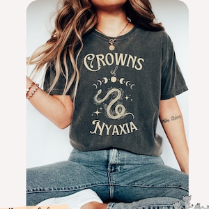 Crowns of Nyaxia The Serpent and The Wings of Night Comfort Colors® tee Carissa Broadbent Officially Licensed merch Nightborn Little Serpent