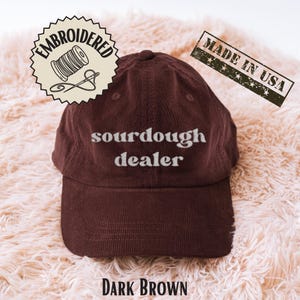 May include: A rustic wooden sign with the text "Welcome to our home" in white lettering. The sign features a distressed finish and a simple, inviting design, perfect for entryway decor.