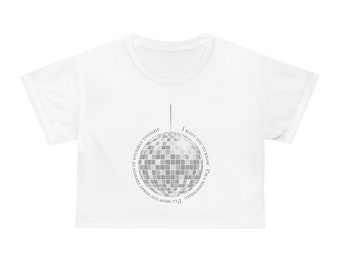 Puede incluir: Top corto blanco con un gráfico de bola de discoteca. El texto alrededor de la bola de discoteca dice: "Quiero que sepas que soy una bola de discoteca, te mostraré todas las versiones de ti mismo esta noche."