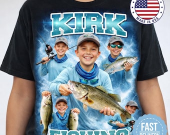 May include: Black t-shirt featuring a graphic of a boy holding a large fish, with the name "KIRK" in blue block letters above and the word "FISHING" below. The design includes multiple images of the boy fishing. A "Made in USA" emblem is visible.