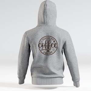 May include: Gray hooded sweatshirt with a brown circle graphic on the back that says "Fueled by coffee and sarcasm".