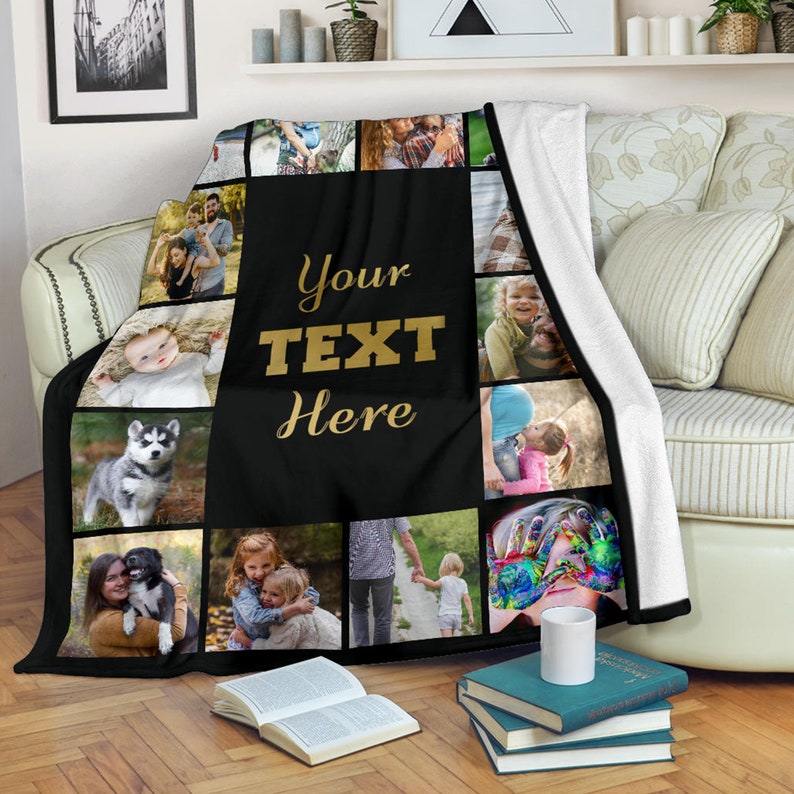 May include: A black fleece blanket with a collage of family photos. The blanket has a black background with white borders around each photo. The text "Your Text Here" is written in gold letters in the center of the blanket.