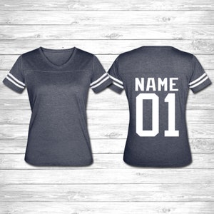 May include: A navy blue jersey with white stripes on the sleeves. The back of the jersey has the word "NAME" and the number "01" in white.